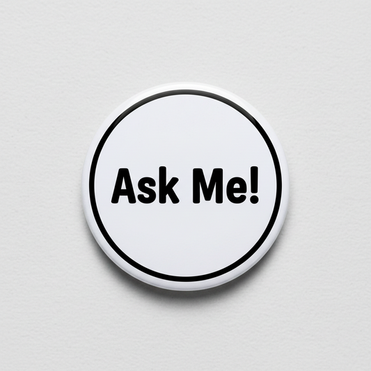 Round pinback button: 'Ask Me!' text with black border