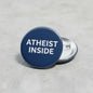 Atheist Inside round blue pinback button with silver clasp and bold white text