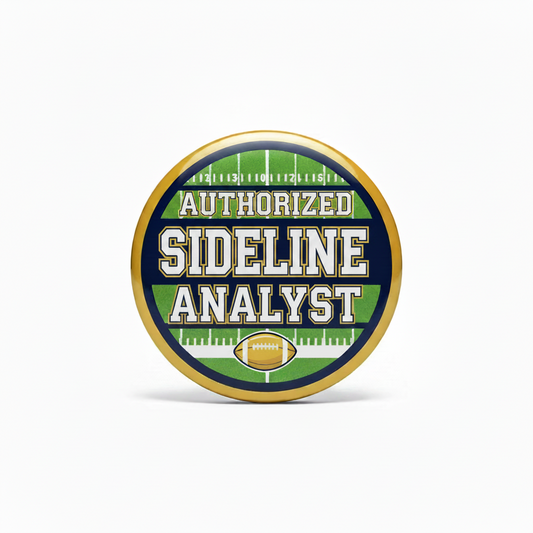 A round, gold-rimmed badge or pin featuring a football field graphic in green and navy blue with the text 'AUTHORIZED SIDLINE ANALYST' and a small football icon at the bottom.