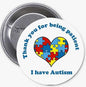1.25-inch autism awareness pinback button with heart puzzle design and blue text