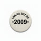 Round pinback button, beige fabric with black text 'LIMITED EDITION 2009-'