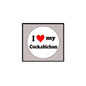 Round pinback button with white face, black “I ♥ my Cockabichon” text, and red heart