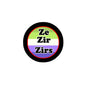 Round pronoun pinback with black rim; 'Ze Zir Zirs' on green and purple face