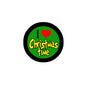 Round pinback button: black rim, green center, red heart, “Christmas Time” text