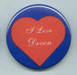 Heart-themed pinback button with blue rim and red heart featuring white 'I Love Devon' text