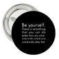 Black round pinback button with motivational quote text, 1.25-inch diameter
