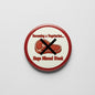 Round red pinback button with vegetarian text and crossed steak icon