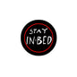 Round black pinback button with red border and white 'STAY IN-BED' text