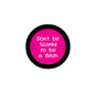 2.25-inch pinback button with pink center and white slogan on black rim