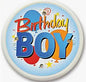Round pinback brooch: blue “Birthday Boy” text with stars and confetti