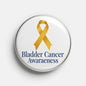 Round metal awareness pin with gold ribbon and blue "Bladder Cancer Awareness" text