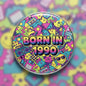 Round pinback button with colorful graffiti-style pattern and text 'BORN IN 1990'.