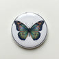 Butterfly badge reel with colorful felt-style butterfly graphic, retractable circular case