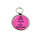 Pink round keychain with crown and 'KEEP CALM AND STAY POSITIVE' text