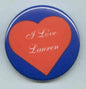 Round pinback button with blue border, red heart, and white "I Love Lauren" text