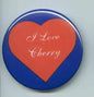Blue heart-shaped pinback button with red Love Cherry text