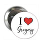 Round pinback button with white front, red heart, and “I Love Gregory” text