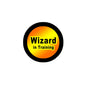 2.25-inch Wizard in Training round pinback badge with black border and orange-yellow text