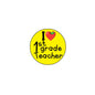 Yellow 1st grade teacher pinback with red heart and apple graphic, reads 'I 1st grade Teacher'