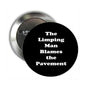 2.25-inch black pinback button with white text 'The Limping Man Blames the Pavement'