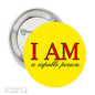 2.25-inch round pinback button with yellow face, 'I AM' and 'a capable person' text