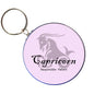 Capricorn bottle opener keychain with round purple disc and goat silhouette, keyring attached