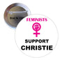 Round pinback button with pin; 'FEMINISTS SUPPORT CHRISTIE' and pink female sign