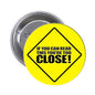 1.25-inch pinback button, yellow with black text 'If you can read this you're too close'