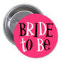 Bride to Be pink pinback button with bold black “BRIDE TO BE” text and metal pin