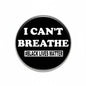 Round black pinback button with white text 'I CAN'T BREATHE' and '#BLACK LIVES MATTER'.