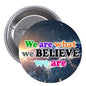 2.25-inch round pinback badge with colorful 'We are what we BELIEVE we are' wording