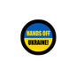 Round pinback button, black rim; blue-yellow design: “HANDS OFF UKRAINE!”