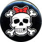 Round black patch with white skull and crossbones, red bow tie accent