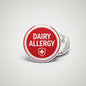 Round red medical alert pinback with white border, DAIRY ALLERGY and cross icon