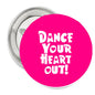 1.25-inch pinback button with pink face and white "Dance Your Heart Out!" text