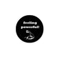Round black pinback button: feeling powerful! with fist graphic