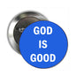 Round metal pinback button with blue face and white text 'GOD IS GOOD'