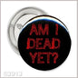 2.25-inch round pinback button with black face and red “AM I DEAD YET?” text