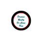 Round pinback badge with black rim, red center, and blue cursive “Dreams Really Do Come True”