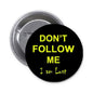 1.25-inch pinback button: black face with yellow 'DON'T FOLLOW ME' and 'I am Lost'