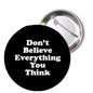 Round black pin with white text: "Don't Believe Everything You Think".