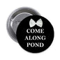 Black pinback button with white bow and 'COME ALONG POND' text