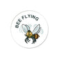 Round pinback button with flying bee illustration and “BEE FLYING” text