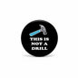 Round black pinback button with wrench graphic and text “THIS IS NOT A DRILL”.