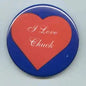 Round pinback button with blue border and red heart reading “I Love Chuck”