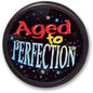 Round black pinback button pin with colorful 'Aged to Perfection' lettering and stars