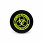 Round black pinback button with green biohazard symbol and ring of text