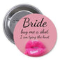 Pink pinback button with Bride text and kiss graphic, 'buy me a shot'