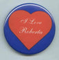 Red heart pinback button with white I Love Roberta text and blue border