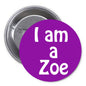 Purple circular button pin with white text "I am a Zoe" and metal back pin